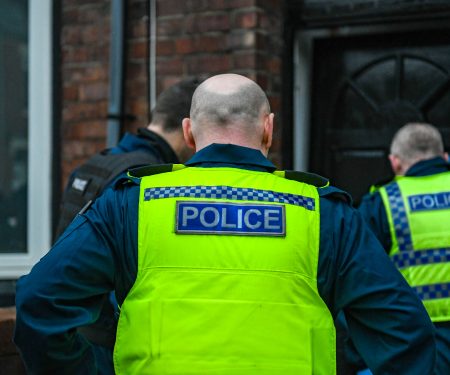 Northumbria Police officers forcing entry to a property as part of a drugs warrant in South Shields.