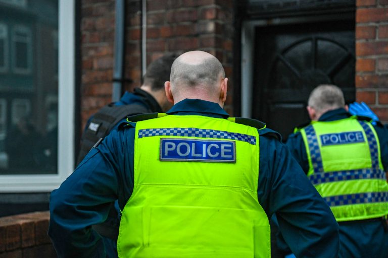 Northumbria Police officers forcing entry to a property as part of a drugs warrant in South Shields.